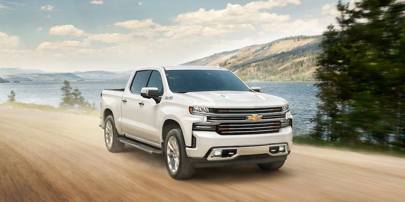 White 2021 CHEVROLET SILVERADO 1500 running on sandy road